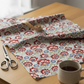 NYSNO Multicolor Floral quilting cotton fabric on bolt with pleated folds showing drape – lifestyle shot for quilters