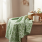 Winter Solstice II Green on White Snow Swirl quilting cotton on bolt with pleated folds – lifestyle shot for quilters