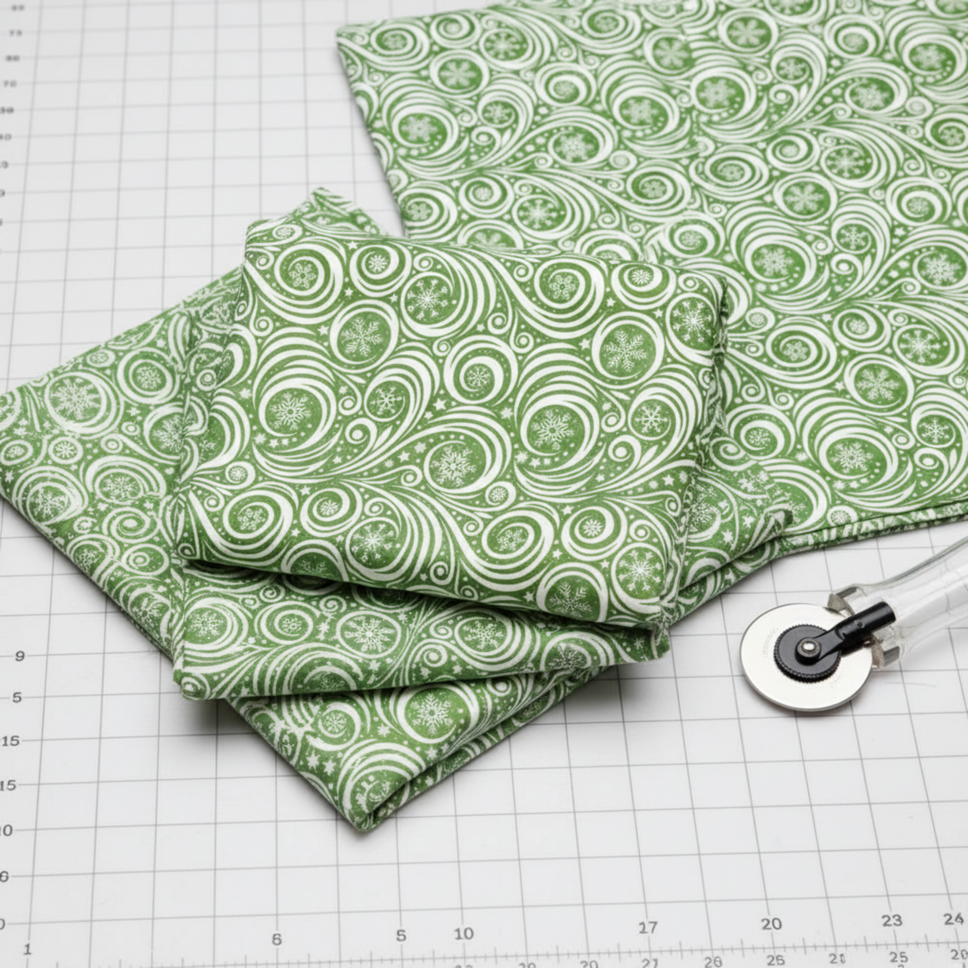 Detailed view of Winter Solstice II Green on White Snow Swirl cotton fabric highlighting elegant swirls
