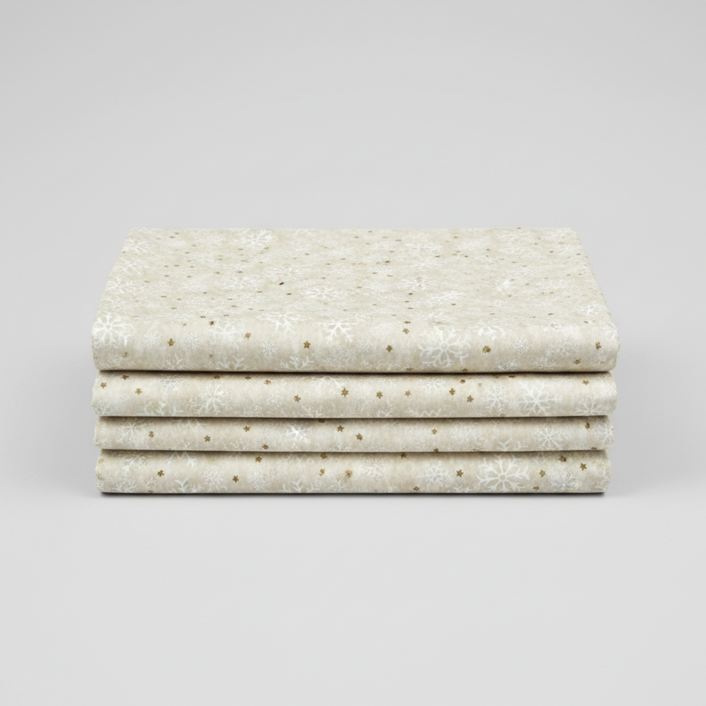 Winter Solstice II Cream Snowflakes Metallic quilting cotton folded stack showing fabric body and drape quality