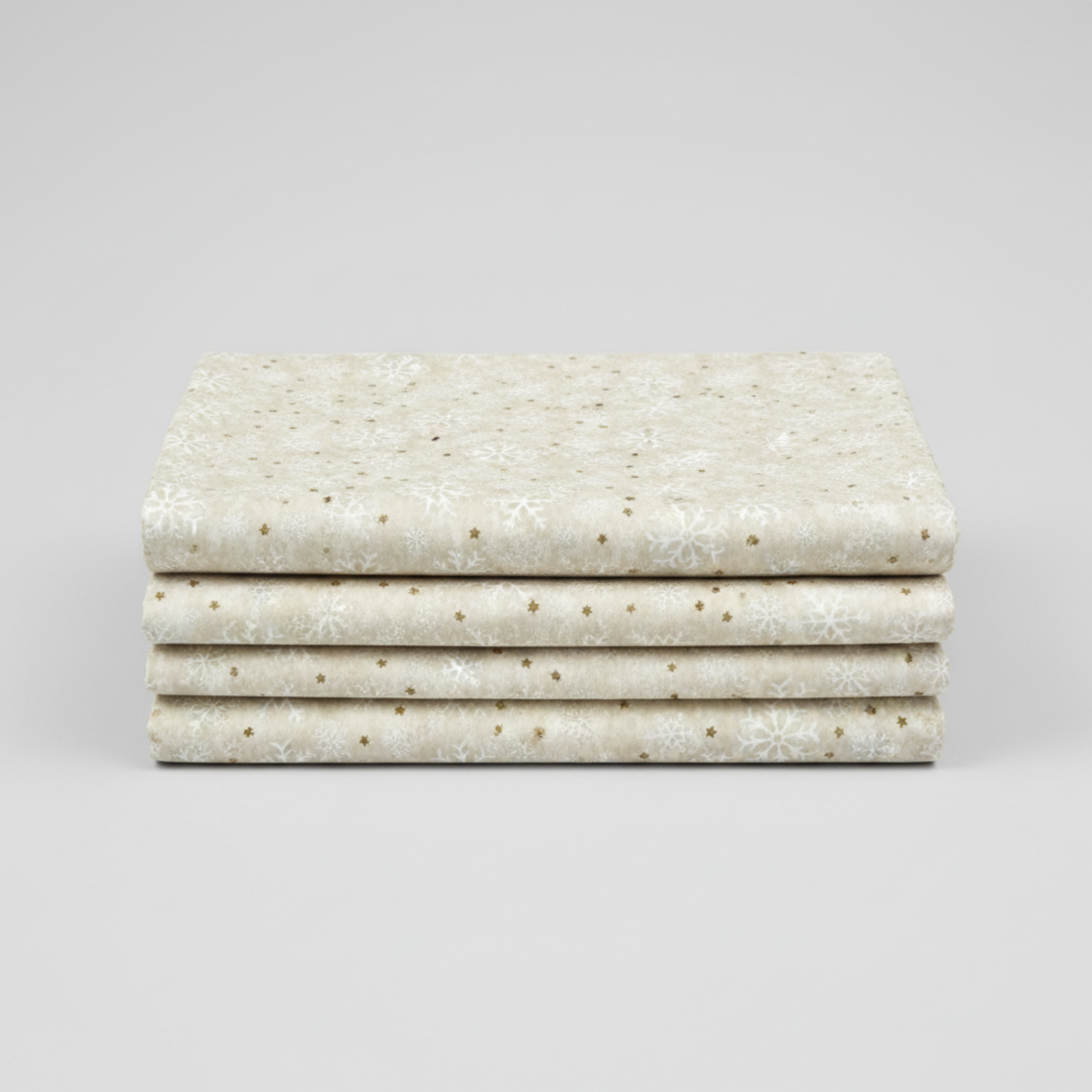 Winter Solstice II Cream Snowflakes Metallic quilting cotton folded stack showing fabric body and drape quality