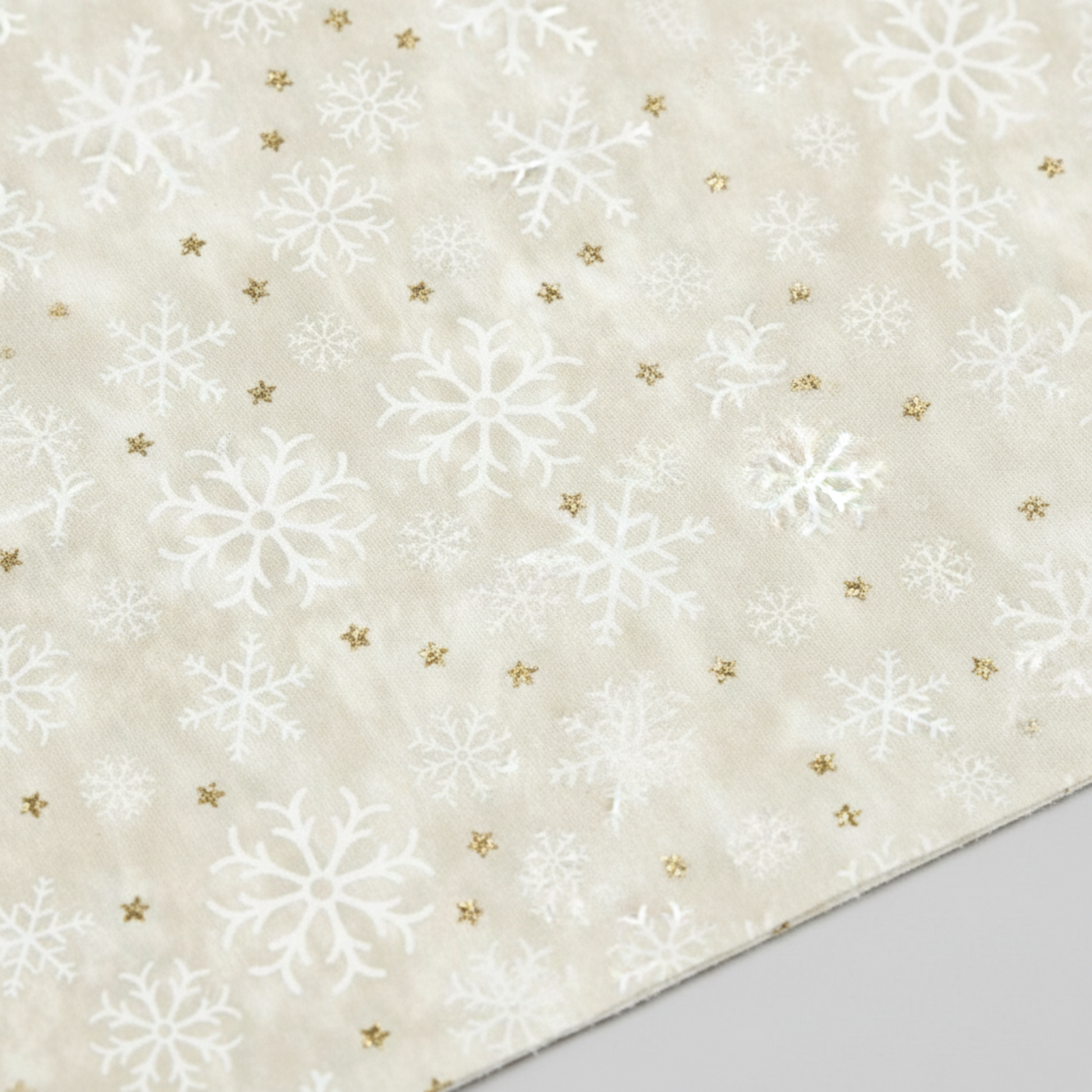 Close-up detail of Winter Solstice II Cream Snowflakes Metallic quilting cotton fabric highlighting print clarity and texture