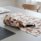 Winter Solstice II Cream Poinsettia Metallic quilting cotton styled in folded stack – lifestyle shot for quilters