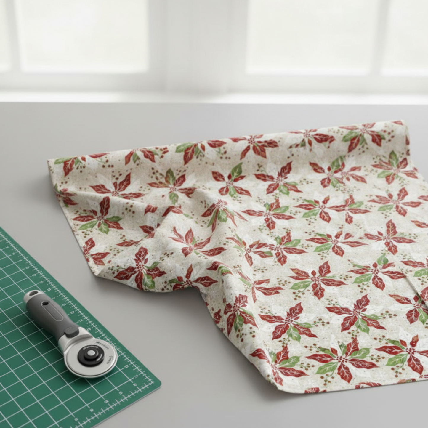 Winter Solstice II Cream Poinsettia Metallic quilting cotton folded stack showing fabric body and drape quality