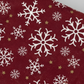 Close-up detail of Winter Solstice II Red Snowflakes Metallic quilting cotton fabric highlighting print clarity and texture