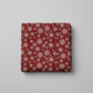 Winter Solstice II Red Snowflakes Metallic quilting cotton folded stack showing fabric body and drape quality