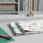 On the Go Tossed Multi quilting cotton folded stack showing fabric body and drape quality