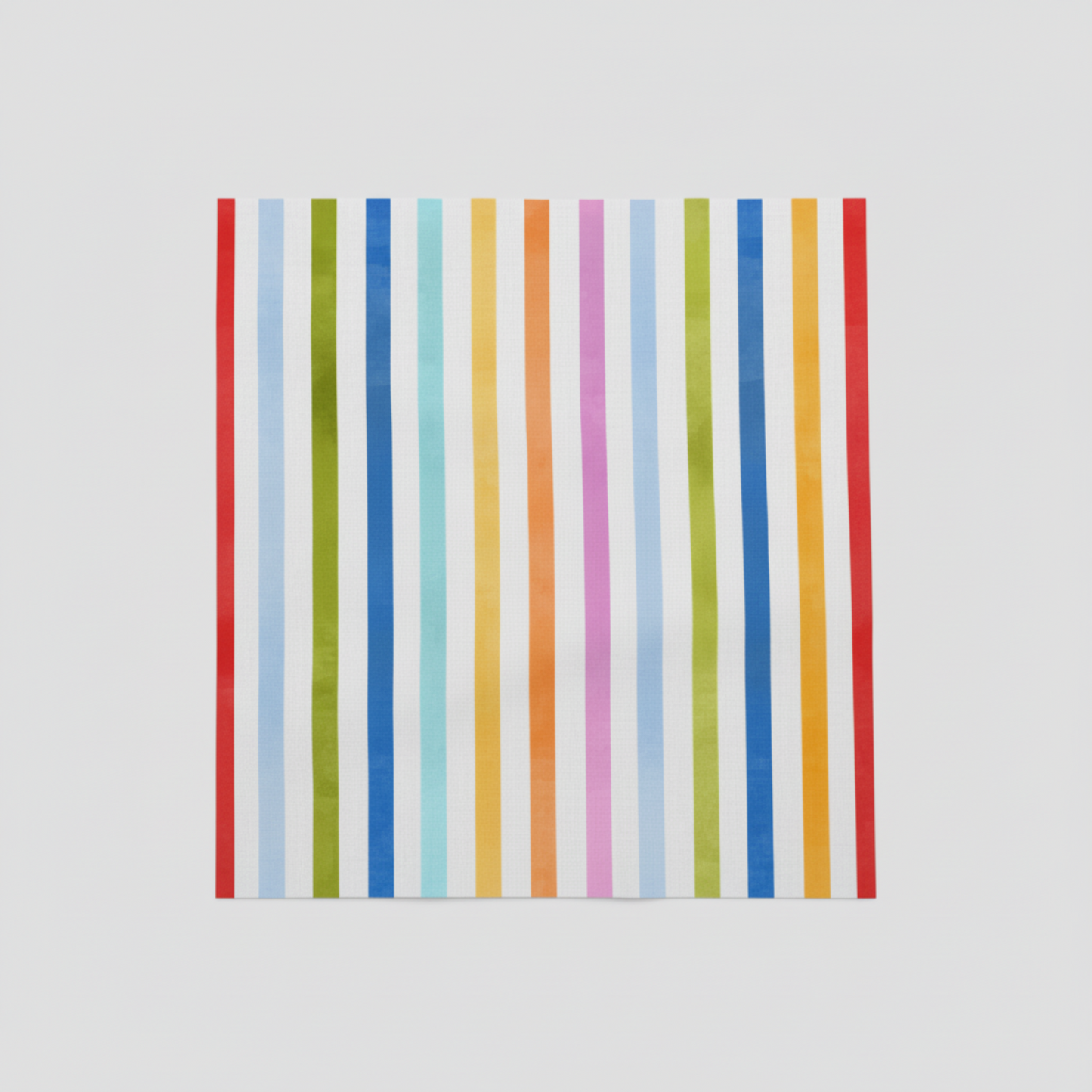 On the Go Stripes Multi quilting cotton displayed on cutting surface, colorful striped print ideal for borders and binding.