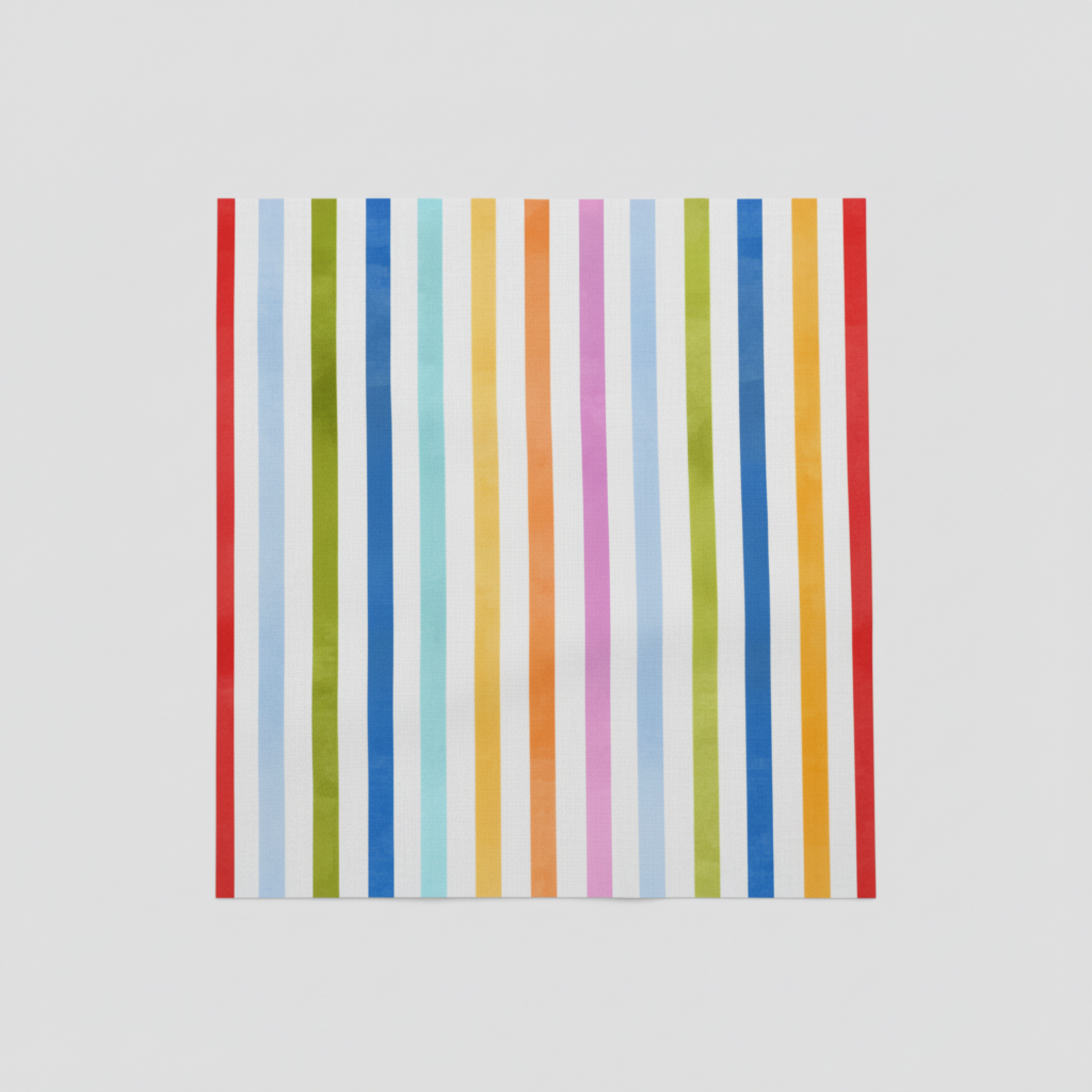 On the Go Stripes Multi quilting cotton displayed on cutting surface, colorful striped print ideal for borders and binding.