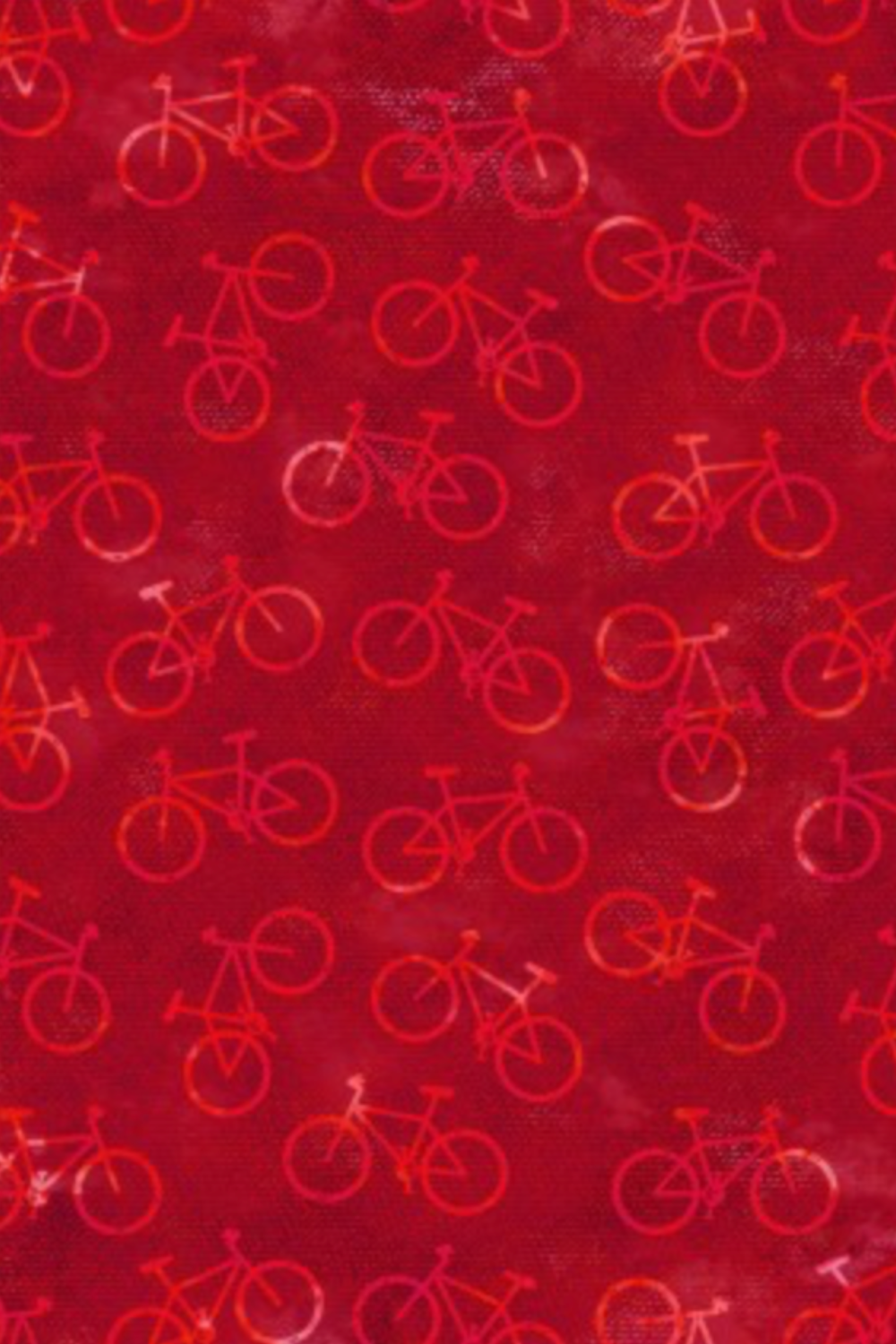 On the Go Bicycles Red quilting cotton by Jason Yenter for In The Beginning Fabrics — vertical crop flat lay showing scattered road bicycle silhouettes in warm crimson on a deep red wax-resist mottled ground. Coordinating fabrics and quilt patterns available at IraRobi Quilts.