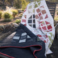 Hopscotch Happy quilt pattern Color and Quilt edition by Robin Pickens — dark navy lap quilt and light botanical colorway displayed outdoors on wooden bench! Shop at IraRobi Quilts! #QuiltPattern #RobinPickens #LayerCake #ModernQuilt #ColorAndQuilt