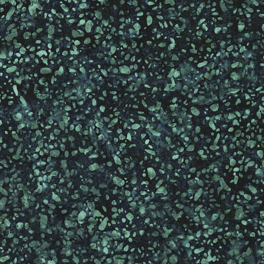 Close-up of Terrazzo Smoky Teal batik fabric by Riley Blake Designs, showing irregular soft teal speckles and mottled texture on a dark navy-teal ground.