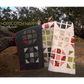 Hopscotch Happy Color and Quilt edition — dark navy and light floral colorways leaning against tree outdoors, showing two colorway options by Robin Pickens