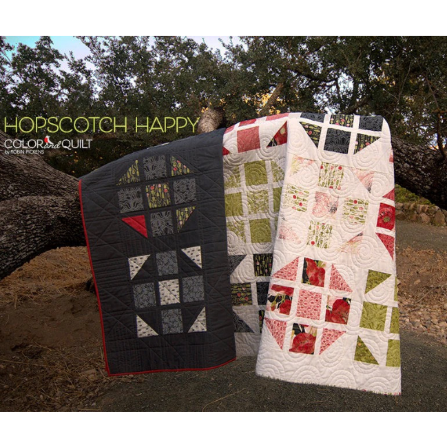 Hopscotch Happy Color and Quilt edition — dark navy and light floral colorways leaning against tree outdoors, showing two colorway options by Robin Pickens