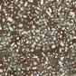 Terrazzo Khaki Fabric by Riley Blake Designs, showing irregular ivory and pale blue-gray flecks across a mottled olive, khaki, and brown background.