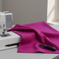 Vertical display of Interwoven Hot Pink quilting cotton showing continuous yardage and geometric pattern repeat