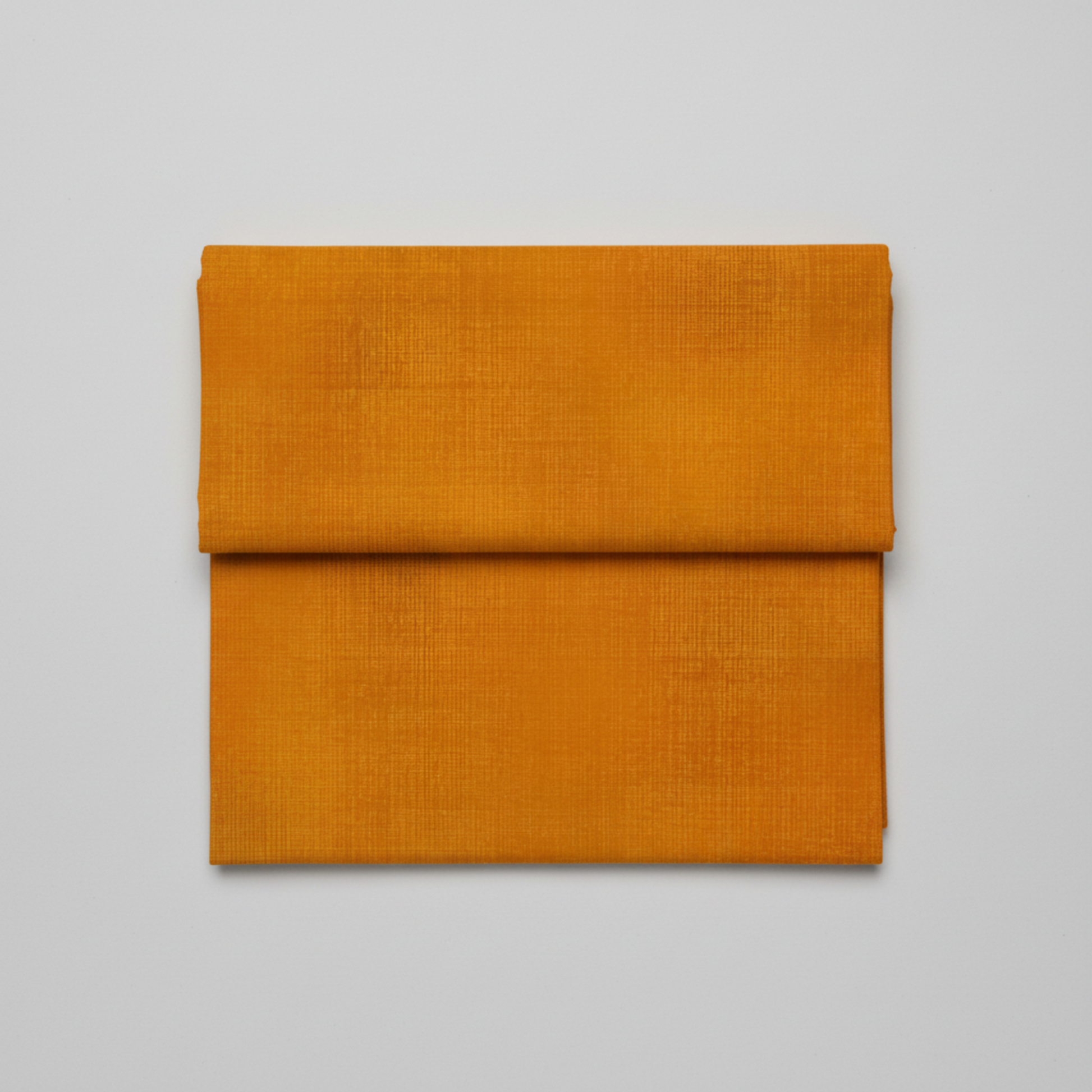 Interwoven Butterscotch quilting cotton showing fabric texture and geometric pattern detail