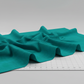 Interwoven Emerald quilting cotton fabric by Jason Yenter showing rich emerald green geometric woven pattern