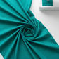 Interwoven Emerald quilting cotton detail showing intersecting lines and jewel-toned green in geometric woven pattern