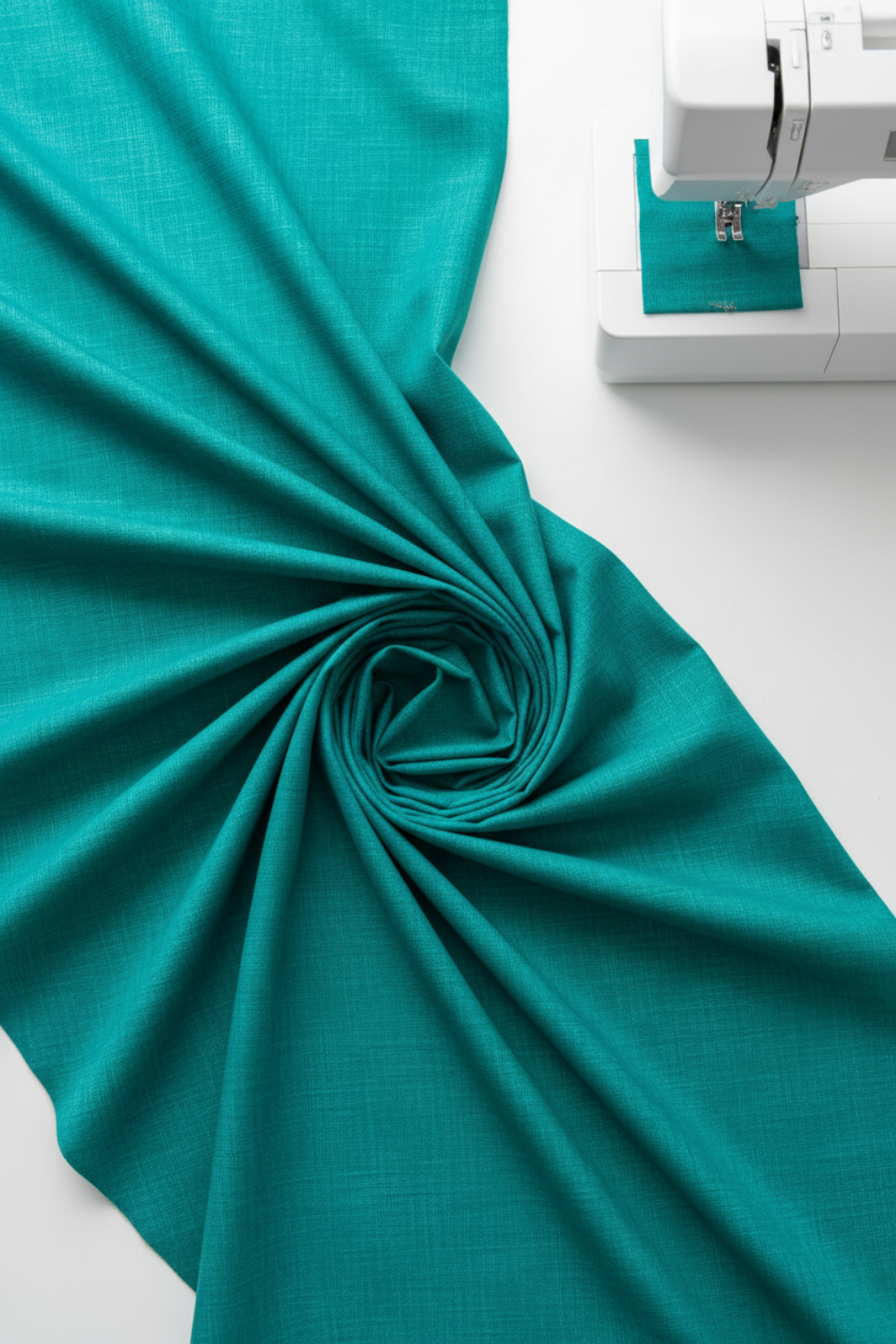 Interwoven Emerald quilting cotton detail showing intersecting lines and jewel-toned green in geometric woven pattern