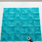 Interwoven Turquoise quilting cotton detail showing intersecting lines and vibrant turquoise tones in geometric woven pattern