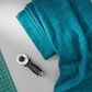 Interwoven Teal quilting cotton lifestyle photo showing draped fabric on cutting table with rotary cutter and cutting mat