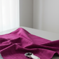 Interwoven Magenta quilting cotton folded on the bolt to show fabric softness and vibrant magenta geometric design