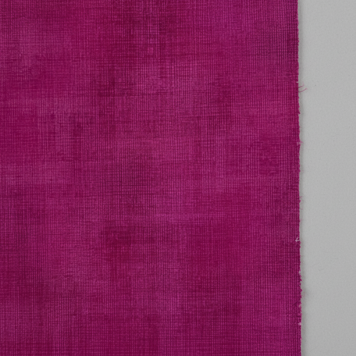Interwoven Magenta quilting cotton showing fabric texture and geometric pattern detail