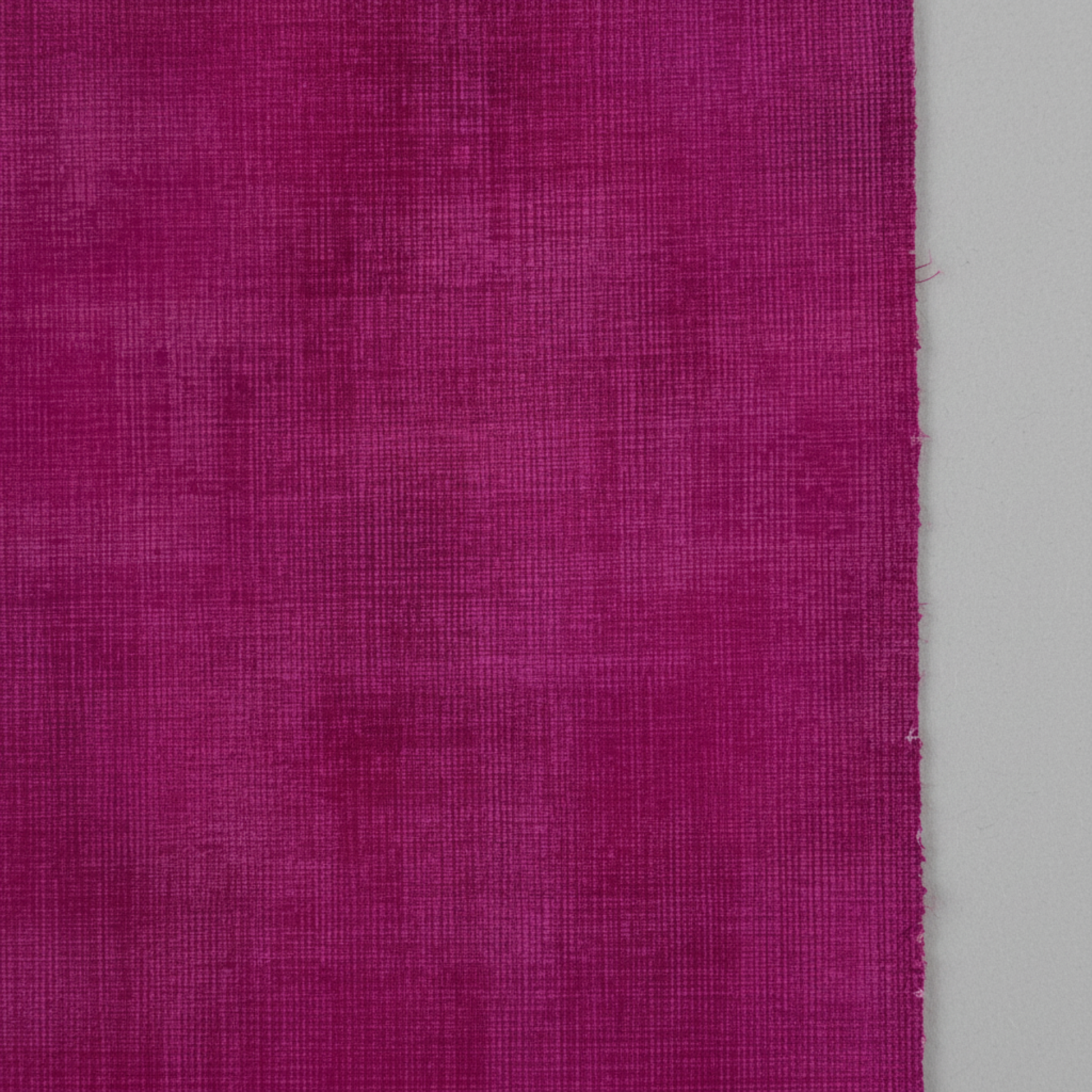 Interwoven Magenta quilting cotton showing fabric texture and geometric pattern detail