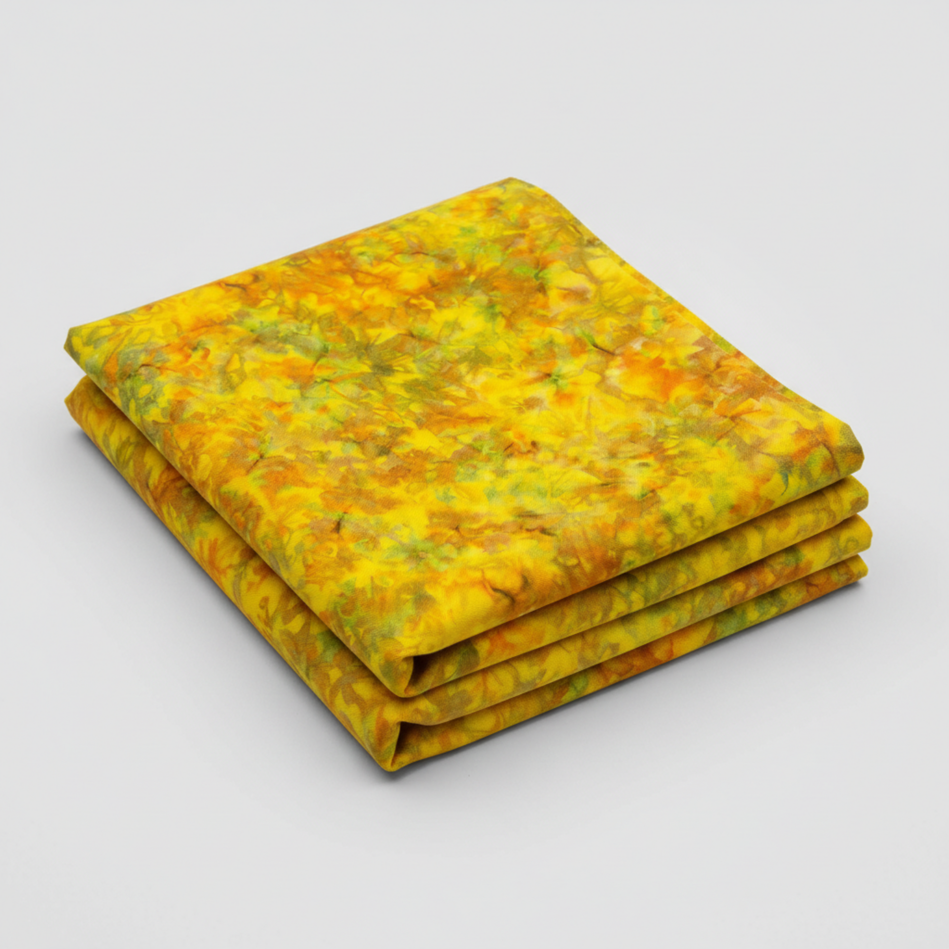 Expressions Batiks Hand-Dyed Yellow Orange Multi 3 quilting cotton fabric by Riley Blake Designs – vivid multicolor hand-dyed batik neatly folded in 3 folds on light grey background showing golden yellow, warm orange, and olive green palette
