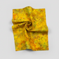 Expressions Batiks Hand-Dyed Yellow Orange Multi III quilting cotton fabric by Riley Blake Designs – Pinterest hero shot, vivid multicolor hand-dyed batik in hurricane funnel drape on light grey background showing golden yellow, warm orange, and olive green palette
