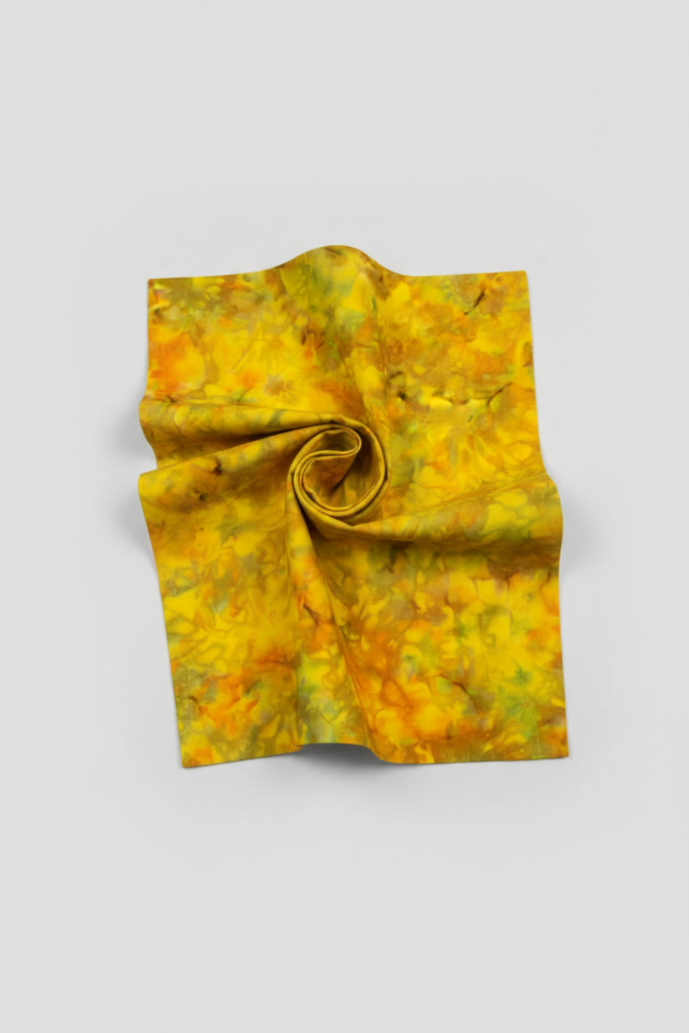Expressions Batiks Hand-Dyed Yellow Orange Multi III quilting cotton fabric by Riley Blake Designs – Pinterest hero shot, vivid multicolor hand-dyed batik in hurricane funnel drape on light grey background showing golden yellow, warm orange, and olive green palette