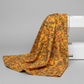 Expressions Batiks Hand-Dyed Orange Multi I quilting cotton fabric by Riley Blake Designs – draped over white sewing machine showing natural drape and movement, complex multicolor hand-dyed batik with golden amber-orange, olive green, slate blue-grey, and red-orange palette, light grey background