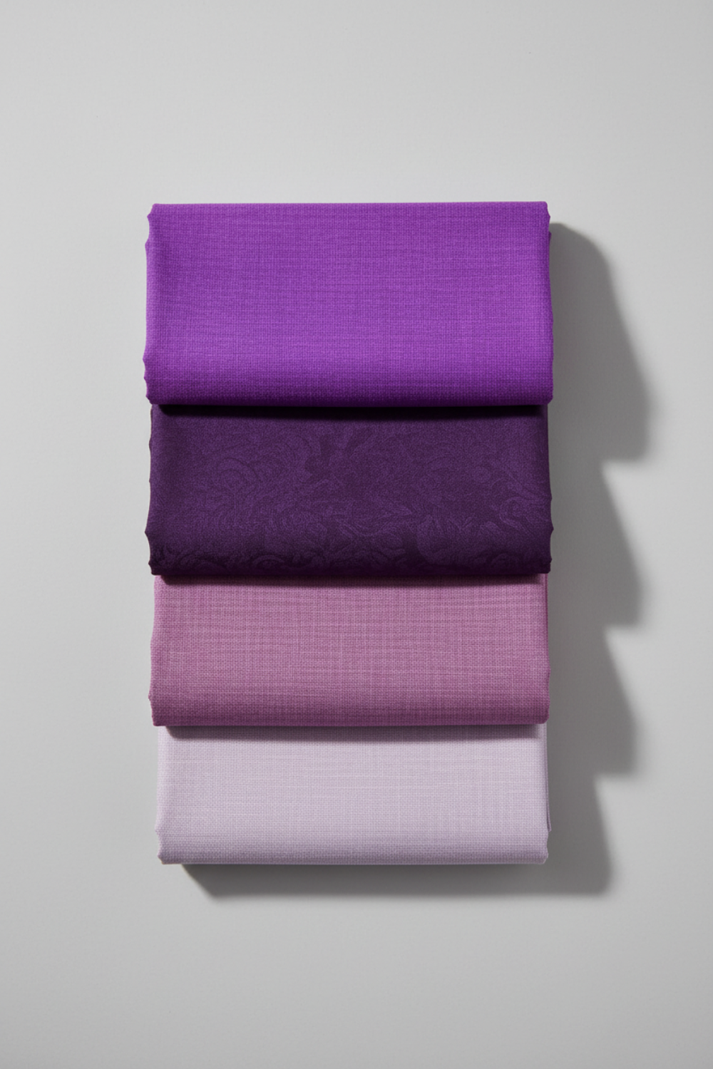 Interwoven Plum by Jason Yenter – Pinterest fabric coordination stack of 3–5 complementary fabrics including Interwoven Plum, stacked vertically on light grey background