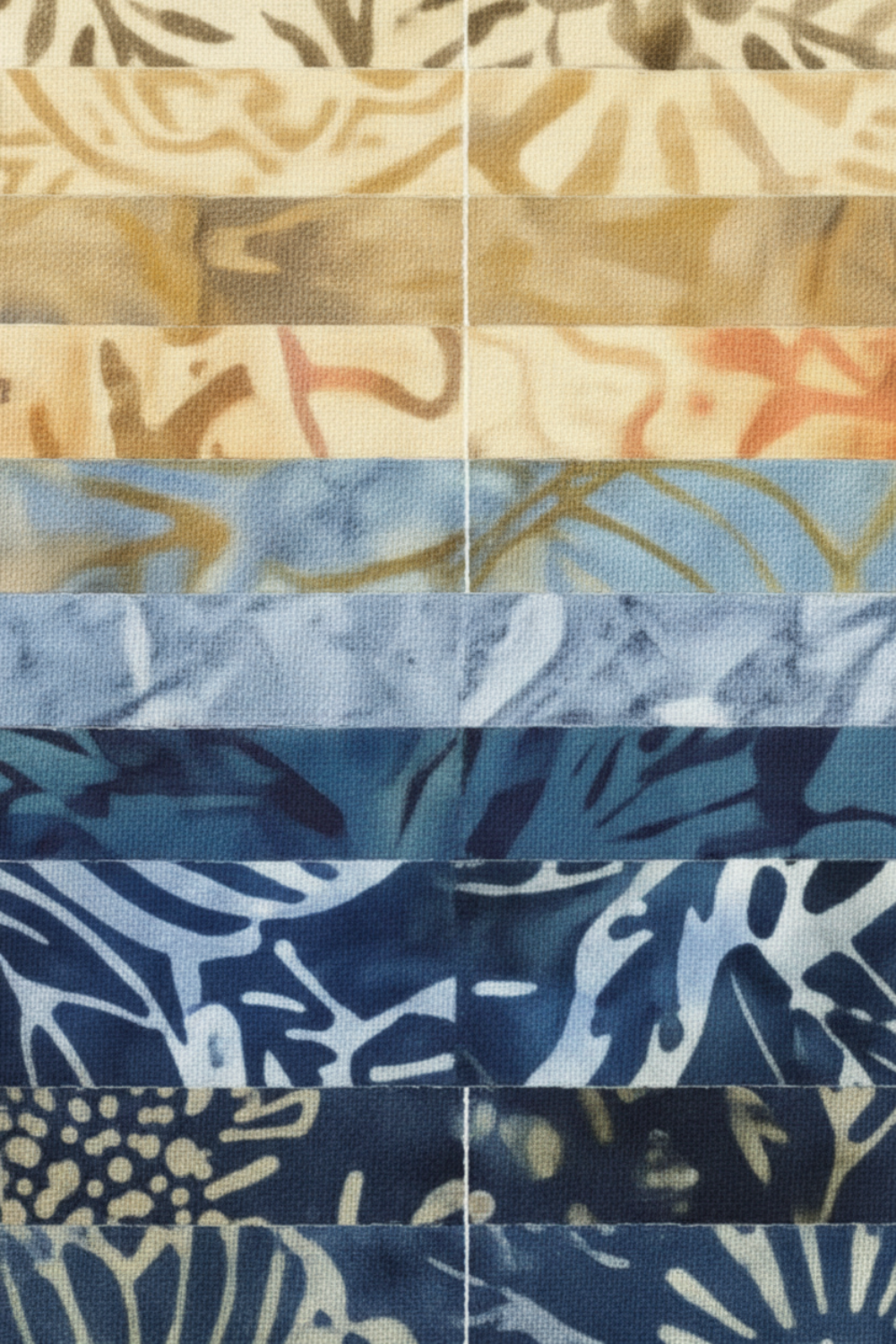 Tonga Batik Moonlit by Timeless Treasures – close-up grid of 2.5" strips showing batik wax resist texture and pattern detail, progressing from cream and warm sand through golden taupe, slate blue, periwinkle, denim, and deep navy with tropical leaf and botanical motifs