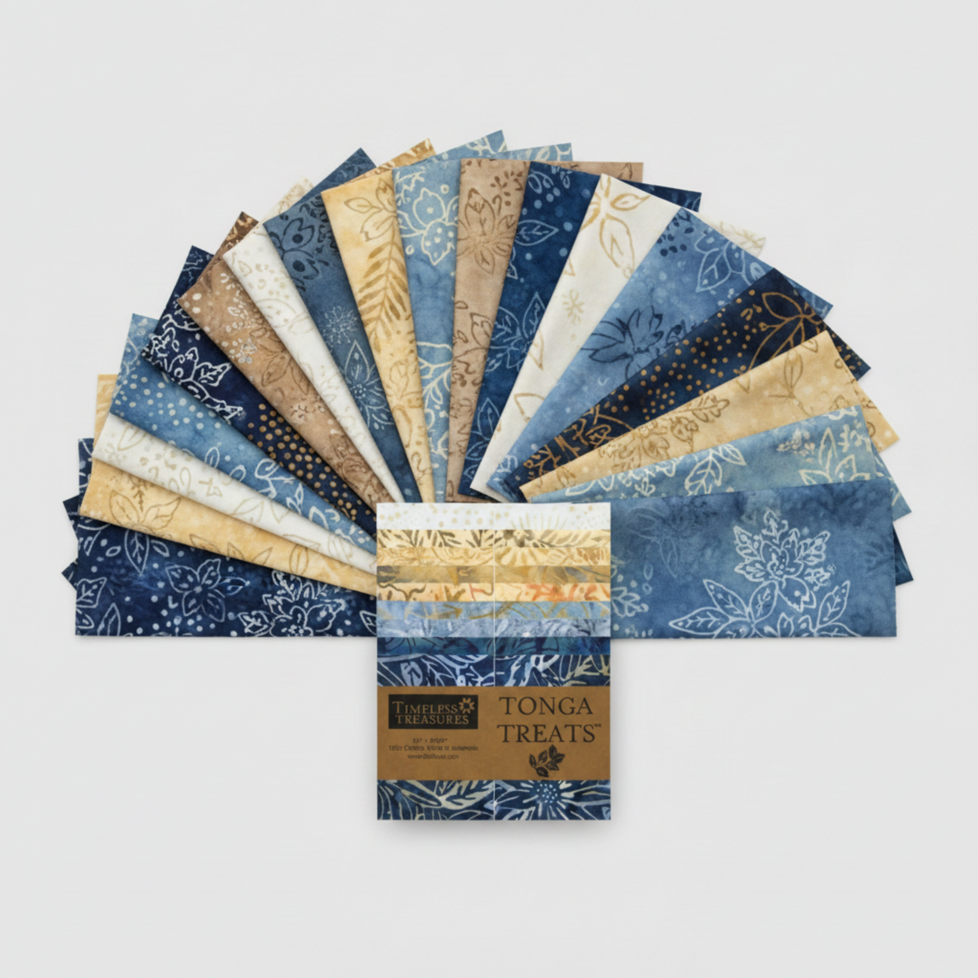 Tonga Batik Moonlit by Timeless Treasures – 40 pre-cut 2.5" strips fanned in wide arc on light grey background with Tonga Treats package, showing full palette of deep navy, denim blue, periwinkle, warm sand, taupe, and cream hand-dyed batik