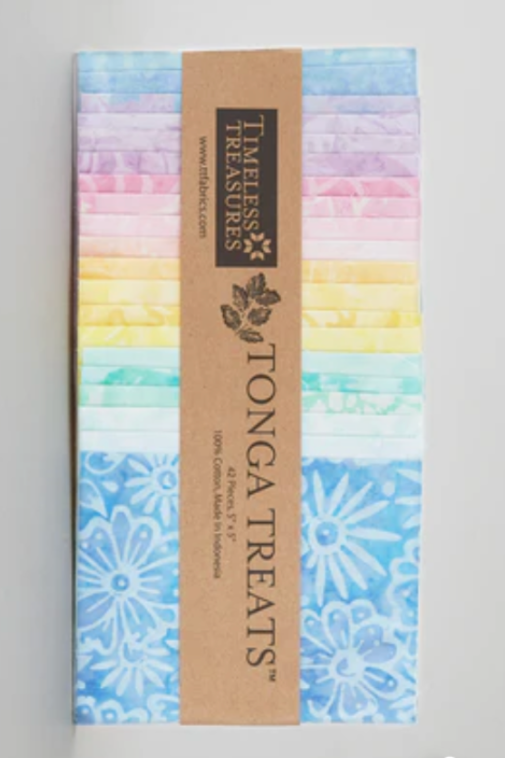 Tonga Batik Pixie by Timeless Treasures – Pinterest pin of Tonga Treats charm pack standing upright showing 42 pre-cut 5" squares in pastel rainbow from lavender and blush pink through soft yellow, mint, aqua, and sky blue hand-dyed batik with daisy motif