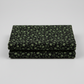 Vintage Charm Green Flower Patch by Judie Rothermel for Marcus Fabrics – folded 1-yard cut showing black cotton with green ditsy floral reproduction print