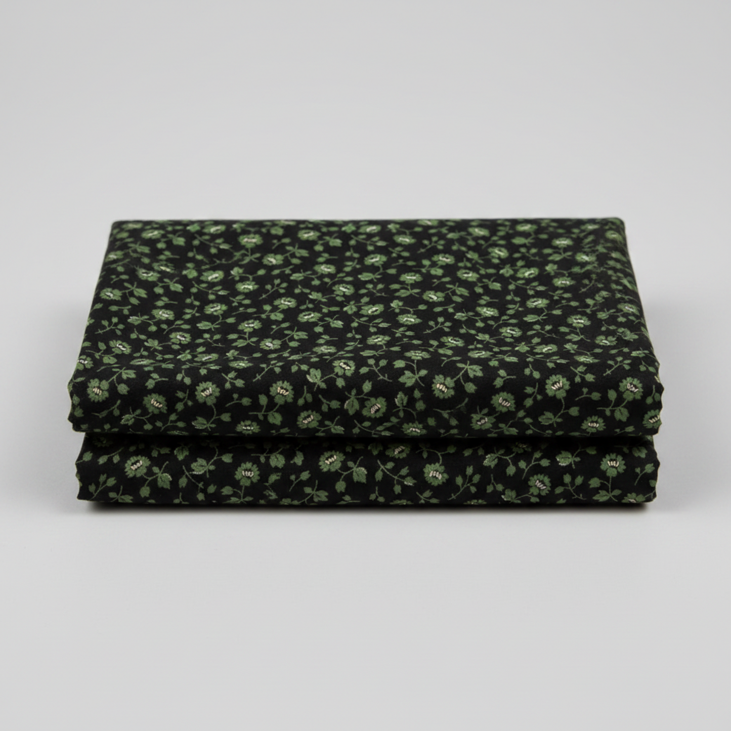 Vintage Charm Green Flower Patch by Judie Rothermel for Marcus Fabrics – folded 1-yard cut showing black cotton with green ditsy floral reproduction print