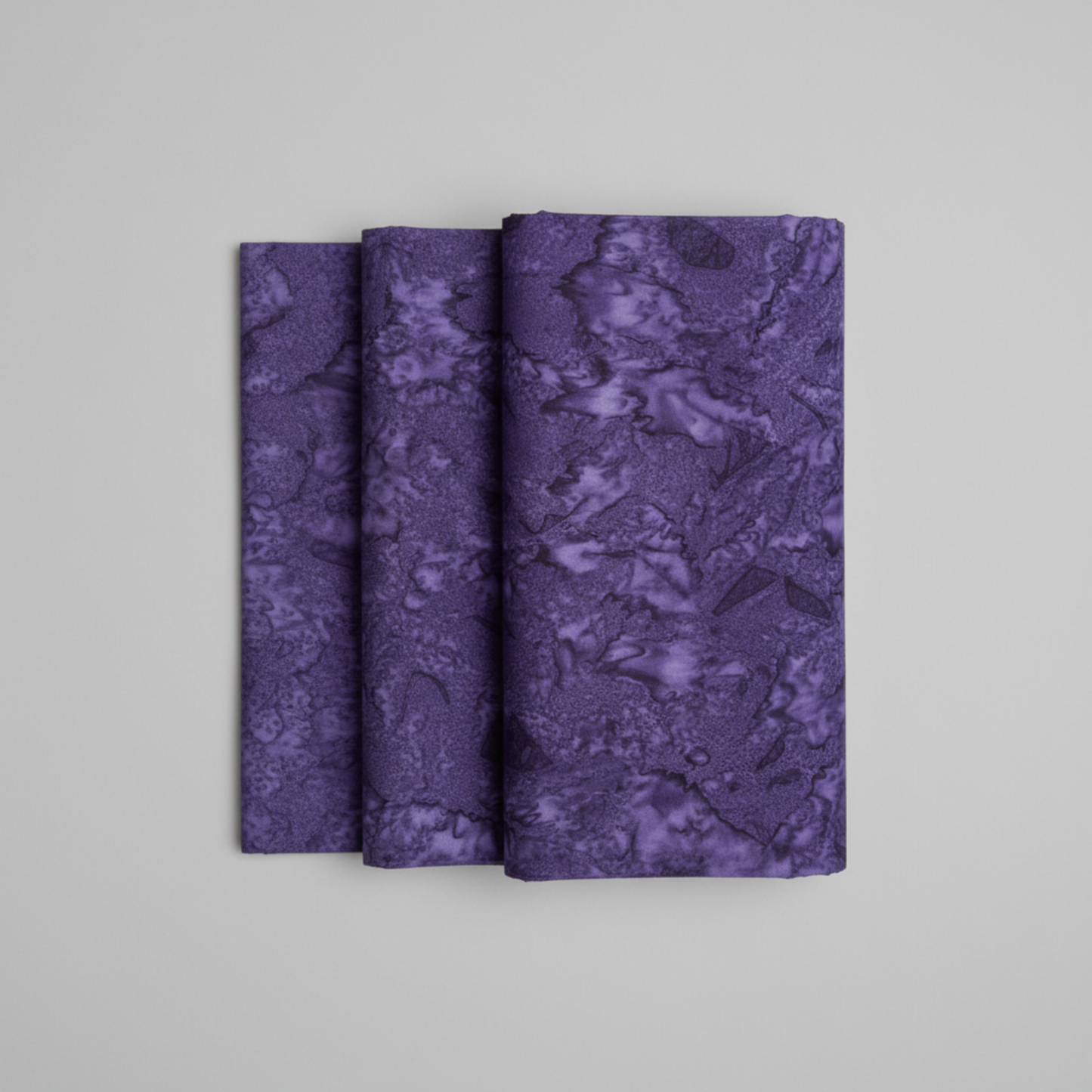Expressions Batiks Hand-Dyed Dark Purple – hero flat lay, deep rich purple hand-dyed batik quilting cotton centered on light grey background, Riley Blake Designs