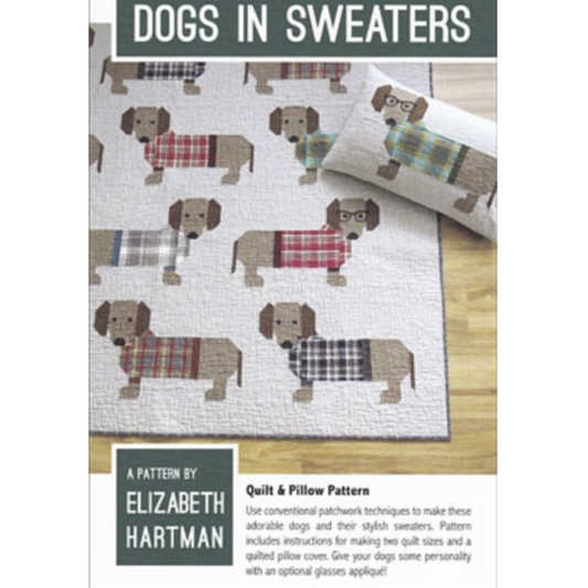 Quilt pattern featuring dogs in sweaters by Elizabeth Hartman on a wooden surface.