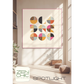 Spotlight quilt pattern by Brigitte Heitland for Zen Chic — bold circle blocks in cream, pink, black, and orange displayed as wall art in a modern living room