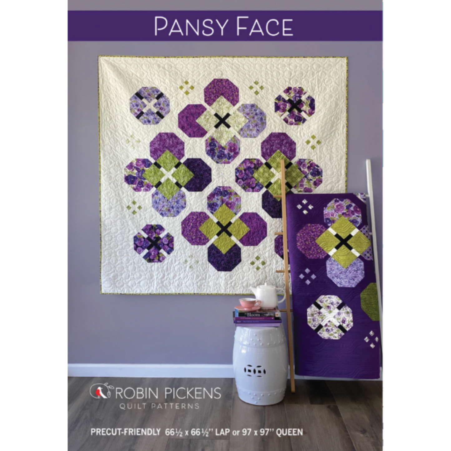 Pansy Face quilt pattern cover by Robin Pickens — purple and green pansy bloom blocks set on point, displayed as wall art with a purple lap quilt on a ladder