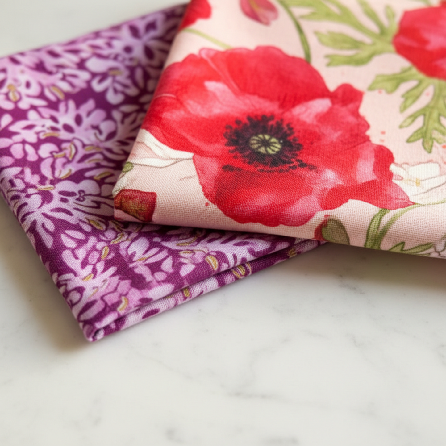 Superbloom fabric by Robin Pickens for Moda Fabrics – folded charm squares showing large red poppy print and purple floral blender