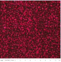 Terrazzo Mahogany fabric by Riley Blake Designs — dark magenta terrazzo speckles on a deep burgundy-mahogany hand-dyed batik, shown with a ruler for scale.