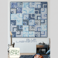 Blue Labyrinth quilt pattern front cover by Zen Chic — modern quarter log cabin quilt in navy, blue and white interlocking squares hung on white wall with guitar and side table, 60 x 60 inches