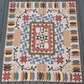 Handmade Patchwork Garden quilt with floral prints and traditional blocks laid flat