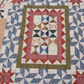 Close-up of traditional patchwork blocks and detailed quilting on Patchwork Garden quilt