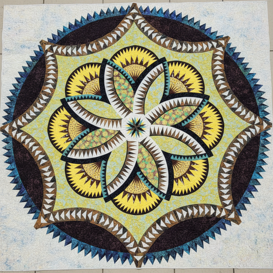 Lily Pond Hosta handmade quilt with intricate batik floral medallion laid flat outdoors