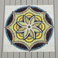 Lily Pond Hosta handmade quilt with intricate batik floral medallion laid flat outdoors